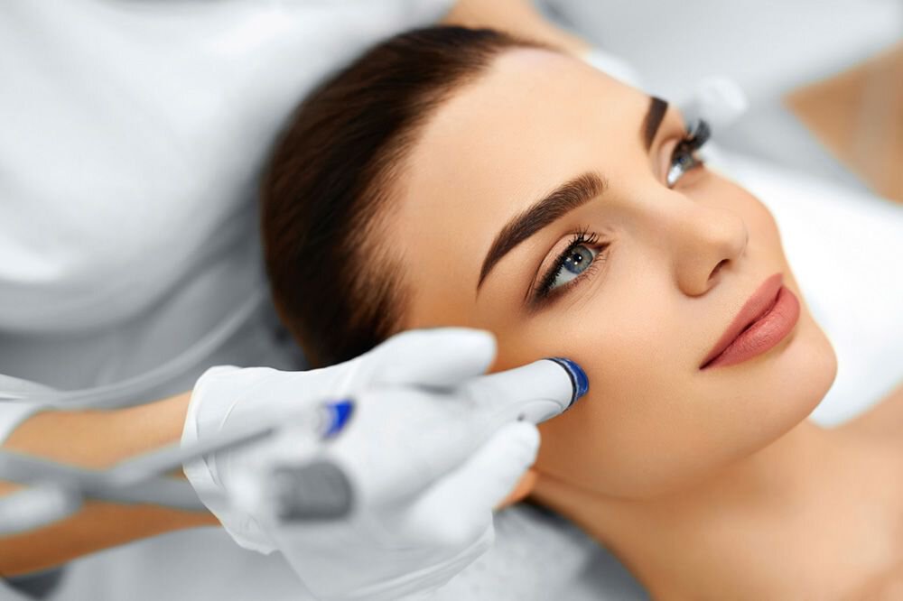 Woman receiving microdermabrasion treatment