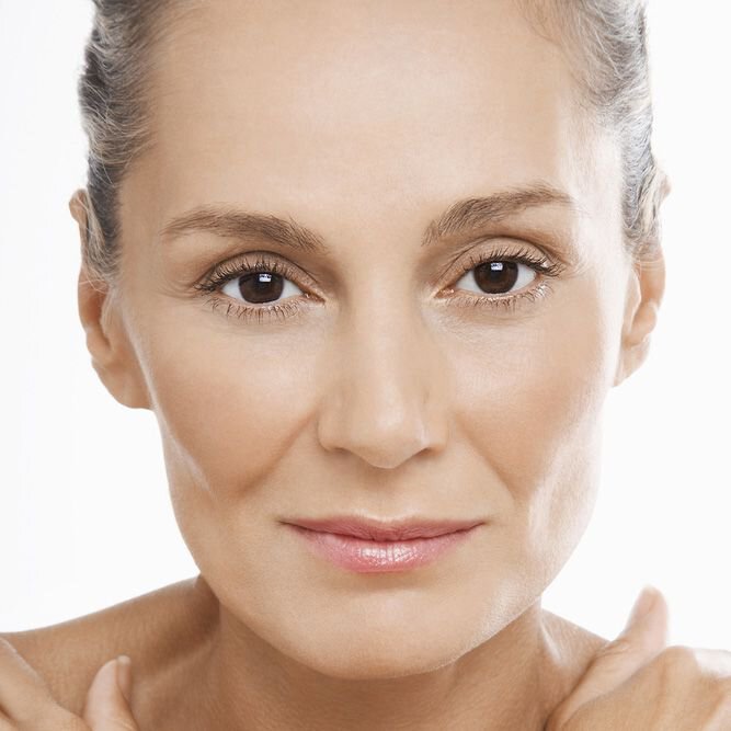 Portrait of beautiful middle-aged woman with smooth skin