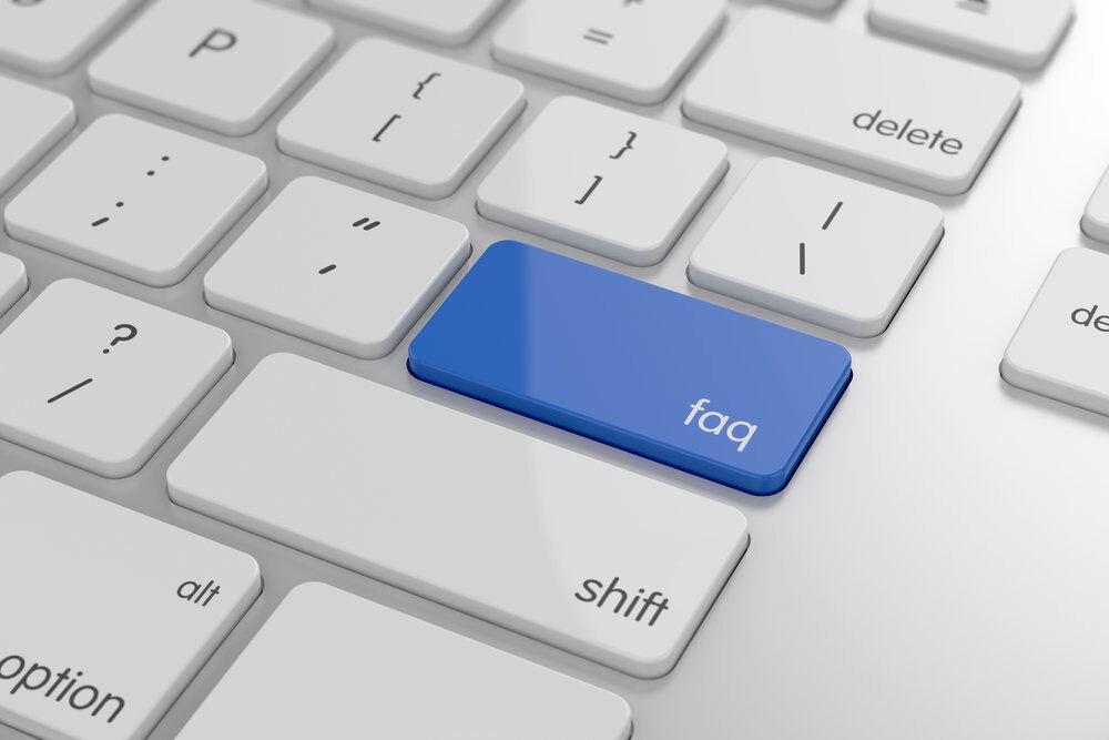 A computer keyboard with a blue “faq” button